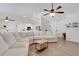 Open living area with a white sectional, wood floors, and easy access to the kitchen at 7642 Habersham Dr, Lakeland, FL 33810