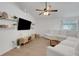 Bright living room featuring neutral paint, a ceiling fan, and modern shelving at 7642 Habersham Dr, Lakeland, FL 33810