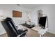 Office space with modern desk and ergonomic rolling chair, view of well-lit, airy living room through doorway at 7642 Habersham Dr, Lakeland, FL 33810