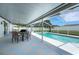 Outdoor patio features table and chairs in view of pool and white fencing surrounding the yard at 7642 Habersham Dr, Lakeland, FL 33810