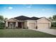 Charming single-story home with neutral colors, a well-manicured lawn, and a convenient two-car garage at 827 Cypress Creek Run, St Cloud, FL 34771