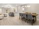 Bright, open-concept living area with wood flooring, modern furnishings, and a view of the dining area at 827 Cypress Creek Run, St Cloud, FL 34771