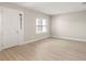 The living room has light, wood-look floors and a window that allows natural light to enter at 827 Cypress Creek Run, St Cloud, FL 34771
