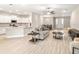 Open-concept living space with modern furnishings and neutral colors flowing into the kitchen and dining areas at 827 Cypress Creek Run, St Cloud, FL 34771