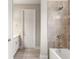 Bright bathroom features a tiled shower, tub, and white vanity with light countertops at 828 Cypress Creek Run, St Cloud, FL 34771