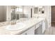 Bright bathroom with dual sinks, granite counters, and tiled walk-in shower at 828 Cypress Creek Run, St Cloud, FL 34771