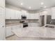 Modern kitchen featuring white cabinets, stainless steel appliances, and granite countertops at 828 Cypress Creek Run, St Cloud, FL 34771