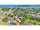 Stunning aerial view of a waterfront neighborhood featuring lush trees, charming homes, and serene blue waters at 841 E Valencia St, Lakeland, FL 33805