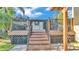 Outdoor deck offers space for dining and lounging with a grill and tropical landscaping at 841 E Valencia St, Lakeland, FL 33805