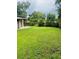 Lush backyard featuring green grass and plenty of space for outdoor activities at 841 E Valencia St, Lakeland, FL 33805