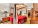 Primary bedroom showcasing a canopy bed with a red comforter and an open closet at 841 E Valencia St, Lakeland, FL 33805