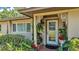Inviting front entrance featuring decorative columns and landscaping, complemented by a glass paneled door at 841 E Valencia St, Lakeland, FL 33805