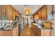 Galley kitchen features wood cabinets, stainless steel appliances, and unique ceiling light at 841 E Valencia St, Lakeland, FL 33805