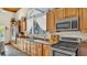 Modern kitchen with wood cabinets, updated appliances, and ample counter space, perfect for cooking and entertaining at 841 E Valencia St, Lakeland, FL 33805