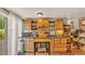 Rustic kitchenette featuring wooden cabinetry, open shelving, and a cozy dining area, perfect for casual dining at 841 E Valencia St, Lakeland, FL 33805