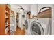 Bright laundry room with updated washer and dryer, ample storage, and charming decor at 841 E Valencia St, Lakeland, FL 33805