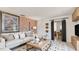 Bright living room boasts a brick accent wall, neutral sofa, and stylish decor at 841 E Valencia St, Lakeland, FL 33805