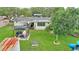 Aerial view of backyard with gazebo, patio, grill, mature landscaping, and a slide at 848 17Th Ne Ter, Winter Haven, FL 33881