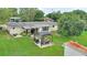 Aerial view of backyard featuring gazebo, patio, seating, grill, and mature landscaping at 848 17Th Ne Ter, Winter Haven, FL 33881