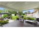 Covered backyard patio with grill, stainless steel prep table, and shaded seating area at 848 17Th Ne Ter, Winter Haven, FL 33881