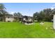 Expansive backyard featuring a gazebo, lush green grass, and mature trees at 848 17Th Ne Ter, Winter Haven, FL 33881