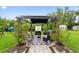 Backyard with patio, gazebo, seating, grill, mature landscaping, and a slide at 848 17Th Ne Ter, Winter Haven, FL 33881