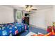 Bright bedroom with ceiling fan, a flat-screen TV, and a playful car-themed comforter at 848 17Th Ne Ter, Winter Haven, FL 33881
