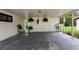 Large carport area with ample space for parking and storage, decorated with hanging plants at 848 17Th Ne Ter, Winter Haven, FL 33881