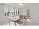 Bright dining room with white tile flooring, natural light from multiple windows, and access to the outdoors at 848 17Th Ne Ter, Winter Haven, FL 33881