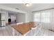 Bright dining room with white tile floors, an oversized wood table, and a view into the entryway at 848 17Th Ne Ter, Winter Haven, FL 33881