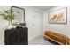 Inviting entryway features a stylish cabinet, mirror, and a cozy bench with blanket at 848 17Th Ne Ter, Winter Haven, FL 33881