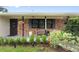Inviting front porch with brick accents, stylish planters, and a welcoming entrance at 848 17Th Ne Ter, Winter Haven, FL 33881