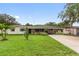 Charming single-story home featuring a well-manicured lawn and covered carport at 848 17Th Ne Ter, Winter Haven, FL 33881