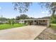 Wide view of a ranch-style home with a brick facade and a spacious carport at 848 17Th Ne Ter, Winter Haven, FL 33881
