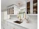 Bright kitchen features white countertops, modern faucet, sink, and white cabinetry at 848 17Th Ne Ter, Winter Haven, FL 33881
