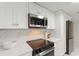 The kitchen features new appliances, stone countertops, and white cabinetry at 848 17Th Ne Ter, Winter Haven, FL 33881