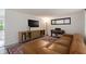 Cozy living room featuring a plush sectional sofa, tv, console, and piano at 848 17Th Ne Ter, Winter Haven, FL 33881