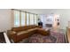 Spacious living room with a plush sectional sofa, bright windows, and patterned rug at 848 17Th Ne Ter, Winter Haven, FL 33881