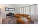 Bright living room with sectional sofa, piano, a patterned rug, and natural light at 848 17Th Ne Ter, Winter Haven, FL 33881