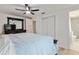 This bedroom features a large bed, and a sliding door closet, with the bathroom en suite at 848 17Th Ne Ter, Winter Haven, FL 33881