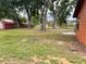 Large backyard with mature trees and partial fencing at 8504 N Campbell Rd, Lakeland, FL 33810