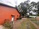 Fenced backyard with a gate, flowers, and a view of the surrounding neighborhood at 8504 N Campbell Rd, Lakeland, FL 33810