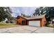 Well-maintained home with an attached garage, long driveway and mature trees at 8504 N Campbell Rd, Lakeland, FL 33810