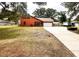Charming home with a well-manicured lawn, long driveway, and attached garage at 8504 N Campbell Rd, Lakeland, FL 33810