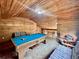 Cozy game room with a pool table, wood-paneled walls and ceiling, and comfortable seating area at 8504 N Campbell Rd, Lakeland, FL 33810
