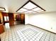 Open floor plan with unique spiral staircase adjacent to a stone fireplace and tiled flooring at 8504 N Campbell Rd, Lakeland, FL 33810
