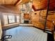 Sunlit living area with wood walls, stone fireplace, spiral staircase, and large windows at 8504 N Campbell Rd, Lakeland, FL 33810