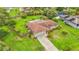 Aerial view of a home with a big backyard, a covered pool, and lush green landscaping at 8535 Plantation Ridge Blvd, Lakeland, FL 33809