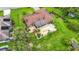 An aerial view of a house with a screened pool in a large backyard with green grass and trees at 8535 Plantation Ridge Blvd, Lakeland, FL 33809