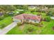 Aerial view of home featuring big yard, covered pool, mature landscaping, and an ample driveway at 8535 Plantation Ridge Blvd, Lakeland, FL 33809